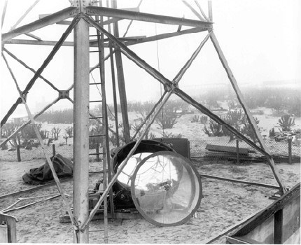 a broken glass panel laying at the base of a tower