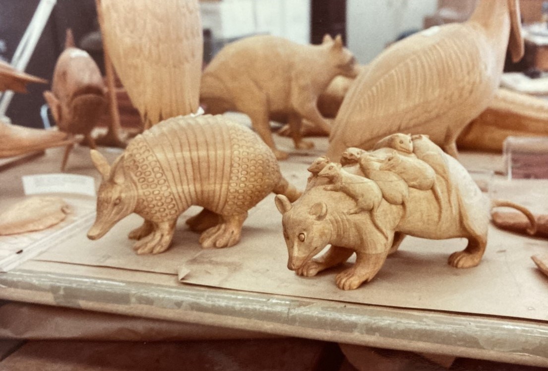 Carved wooden opossum with babies and armadillo