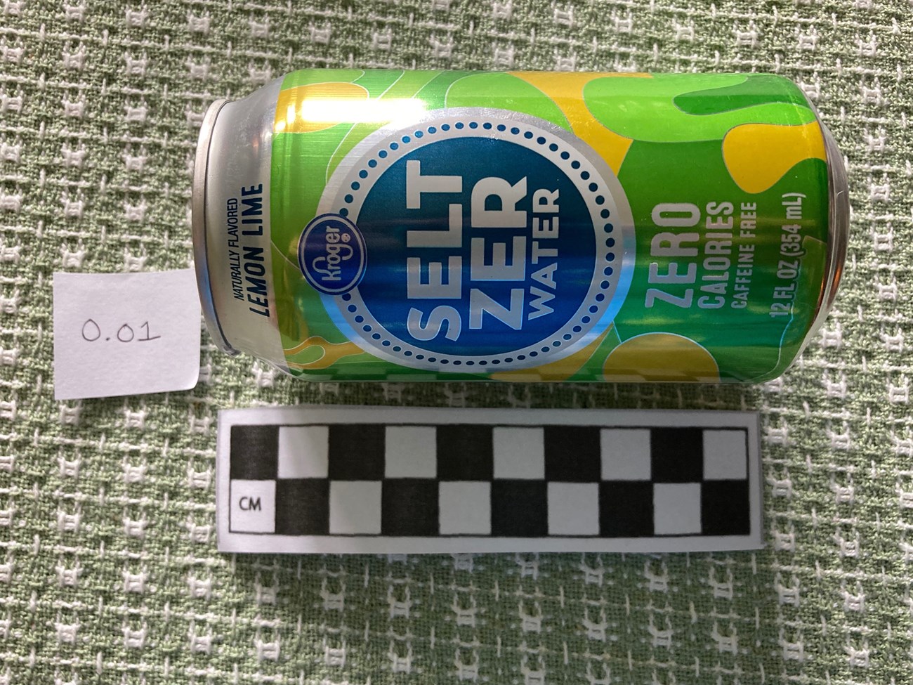 Measure the "Artifacts" Image of a soda can being measured by a ruler.