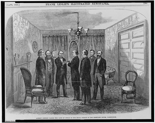 Andrew Johnson in a room with a few other men being inaugurated as president