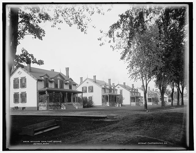 Row of houses along a dirt road.