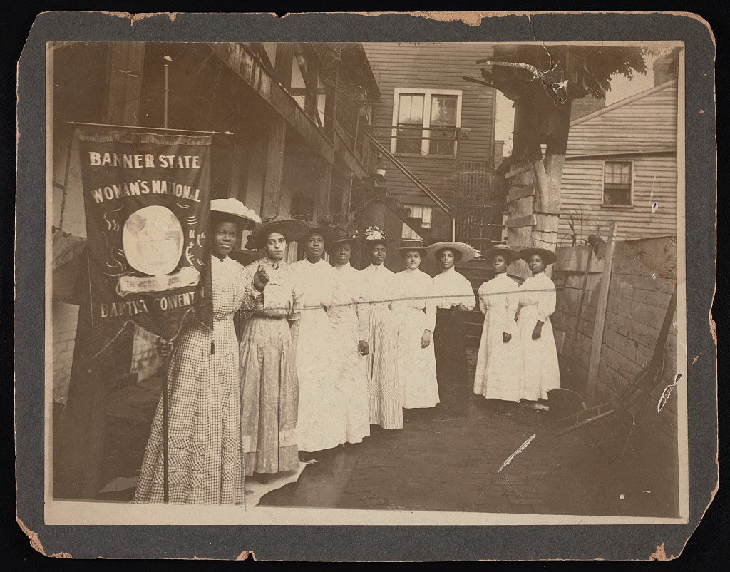 Nannie Helen Burroughs holding banner.