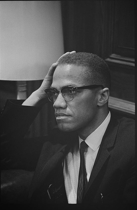 Malcolm X looking to the left.