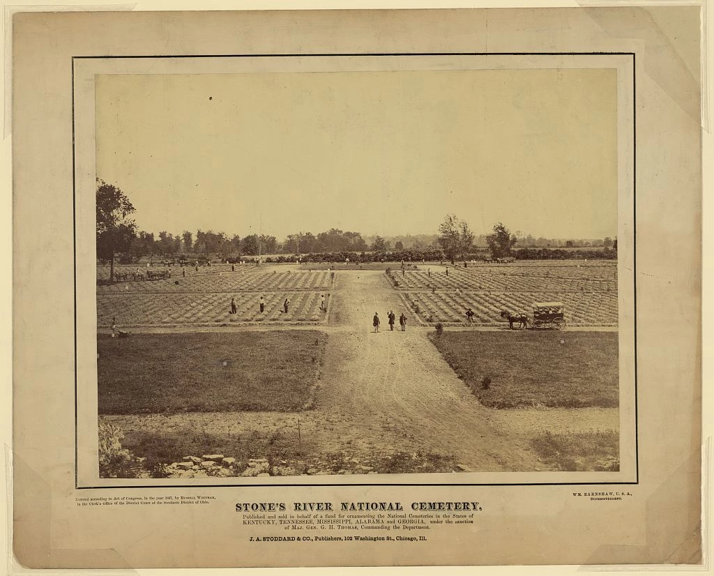 Stones River National Cemetery 1867 People, some with shovels, and a horse-drawn cart scatter across a landscape where broad walkways divide rows of burials.