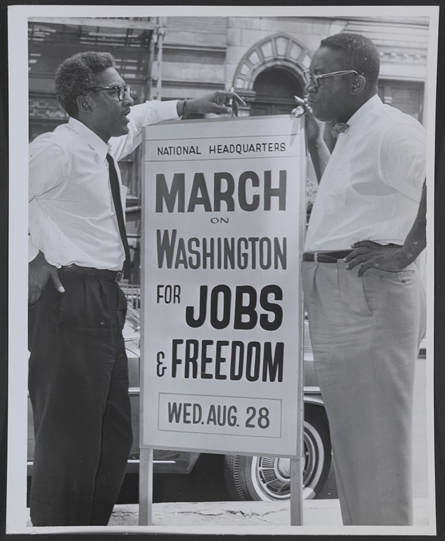 Two men holding sign promoting March on Washington