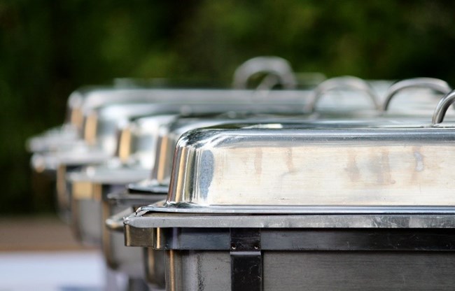 A row of silver serving trays