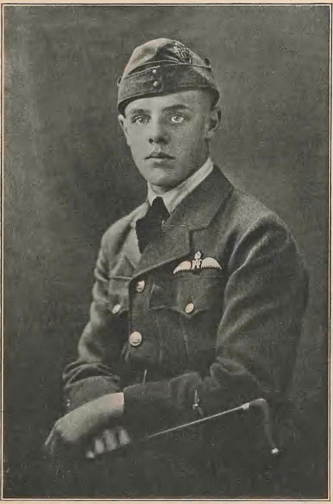 Man in uniform sitting for formal black and white portrait