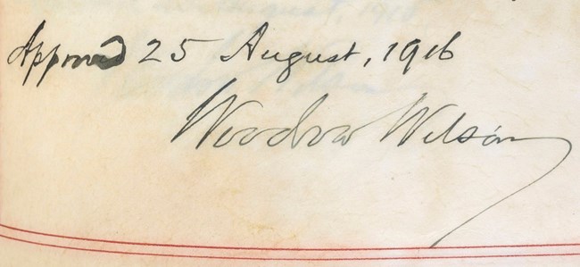 Woodrow Wilson's signature on the Organic Act Detail of a page with "Approved 25 August, 1916" and "Woodrow Wilson" handwritten in ink.