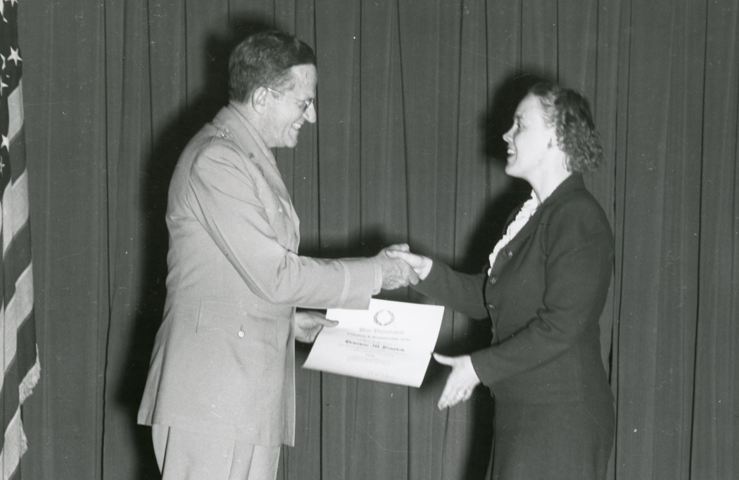 Genevieve Grotjan Feinstein receiving an exceptional civilian service award from Brig. Gen. P.E. Peabody in May 1946