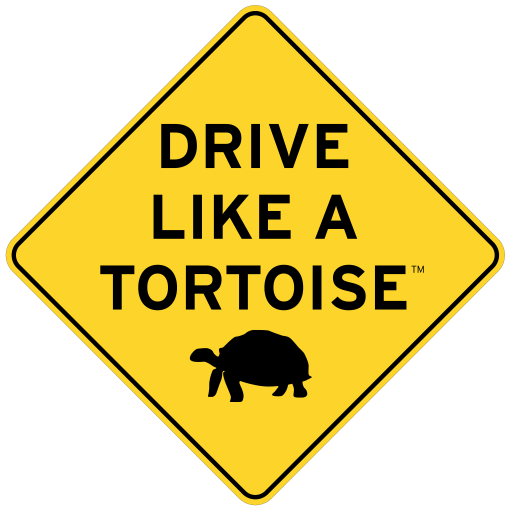 Yellow Diamond shaped sign with text Drive like a tortoise with black tortoise outline