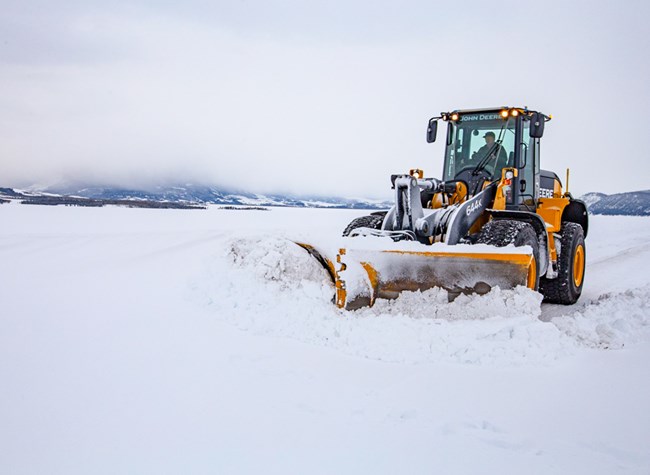 Snowplow works to plow snow from roadway.