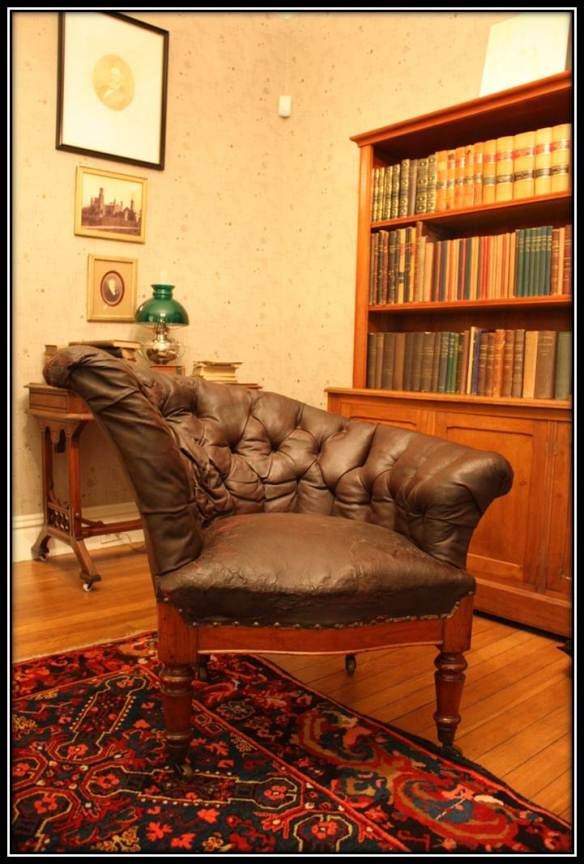 snuggery sideways chair reading chair that is upholstered with black leather