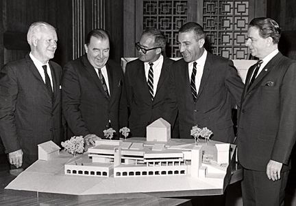 Model of Interpretive Design Center Five men stand behind a model of Interpretive Design Center