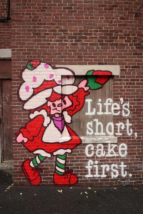 Brick buildings with colorful painting of strawberry shortcake cartoon