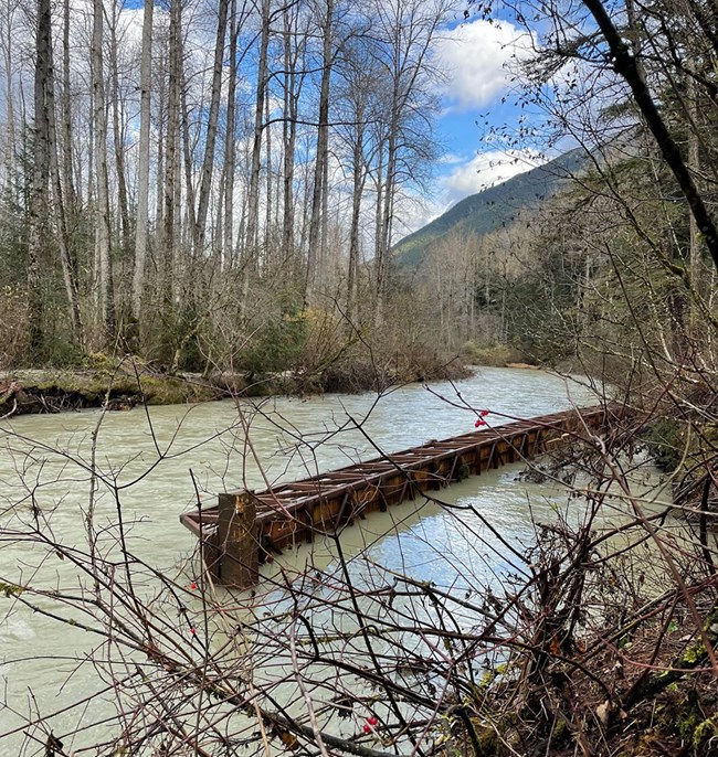 Hiking bridge submerged in high water.