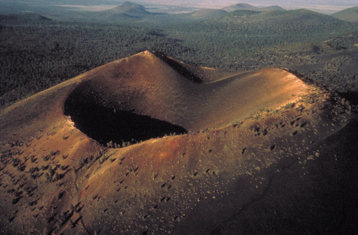 aerial view of a cinder cone and volcanic landscape