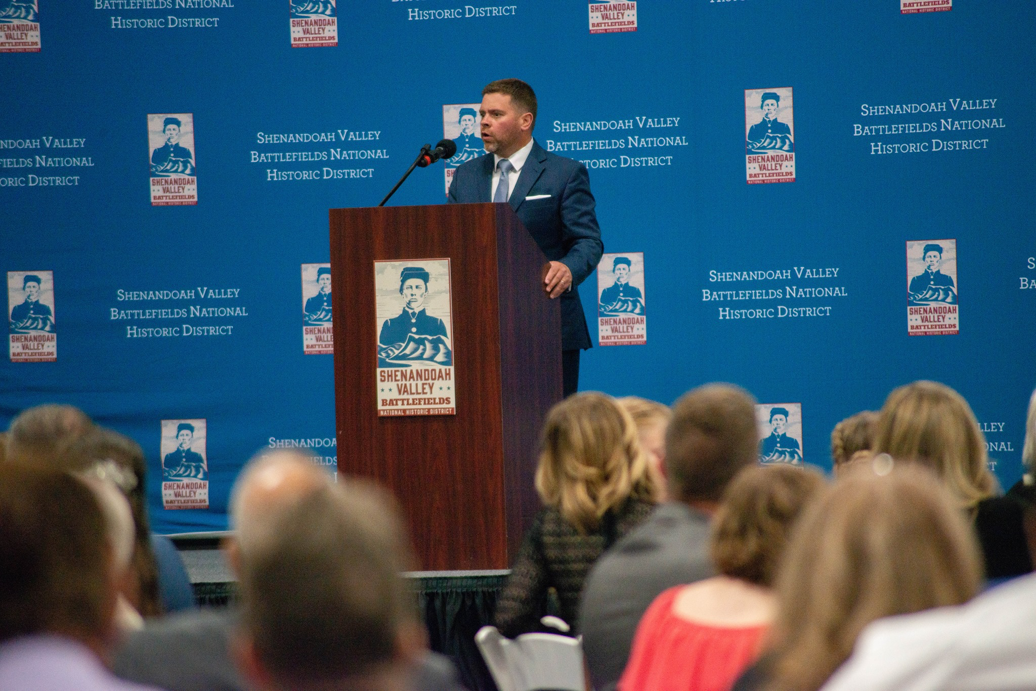 SVBF Man stands speaking at podium