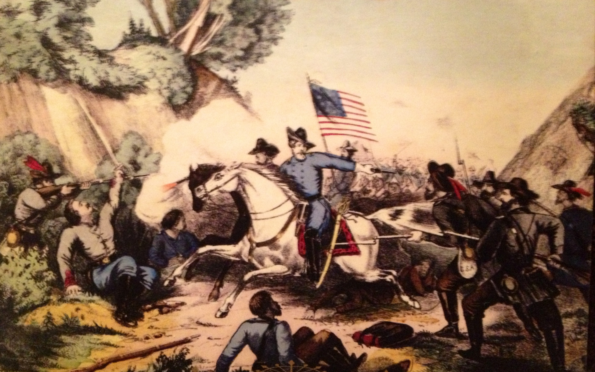 Battle of Fisher's Hill, SVBF Historic illustration of frenzied battle. In foreground, man in blue uniform on white horse charges holding up American flag. He approaches two grey-uniformed men crouched by bushes at left, one holding sword and one aiming gun at other soldiers.