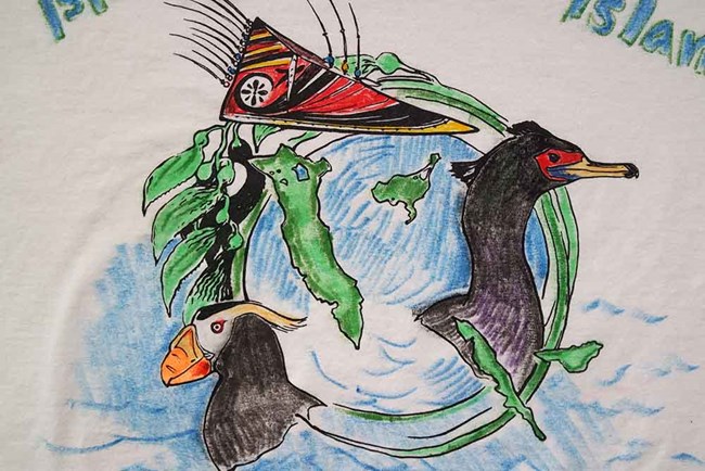 the 2017 t-shirt logo_Ann Harding_web Drawing of islands in the Bering Sea with seabirds and traditional native headdress.