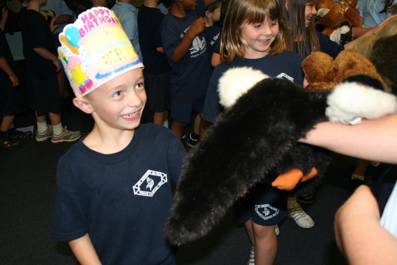 A pre-K student gets to meet a Bald Eagle while celebrating their birthday during the 5th grade puppet show. Photo provided by Lynn Maun.