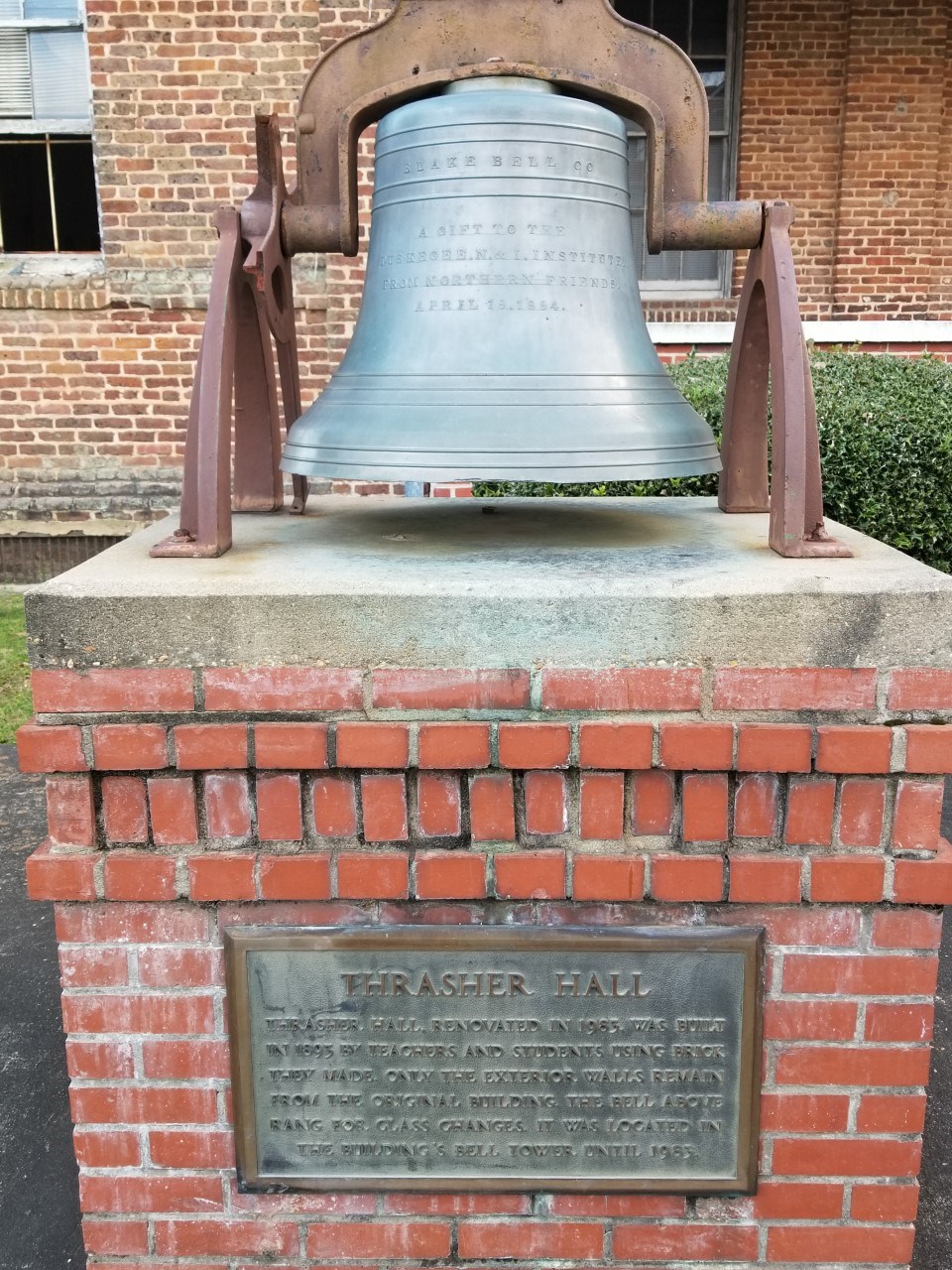 Front view of the original bell from the Thrasher Hall bell tower.The original bell that was housed in the bell tower of Thrasher Hall. There is a plaque explaining a brief history of the bell.
