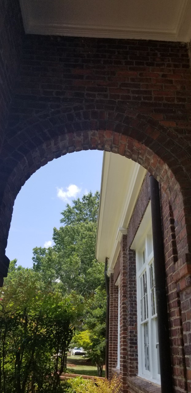 One of the many arches that are implemented into the building's exterior design Brick arch design on building