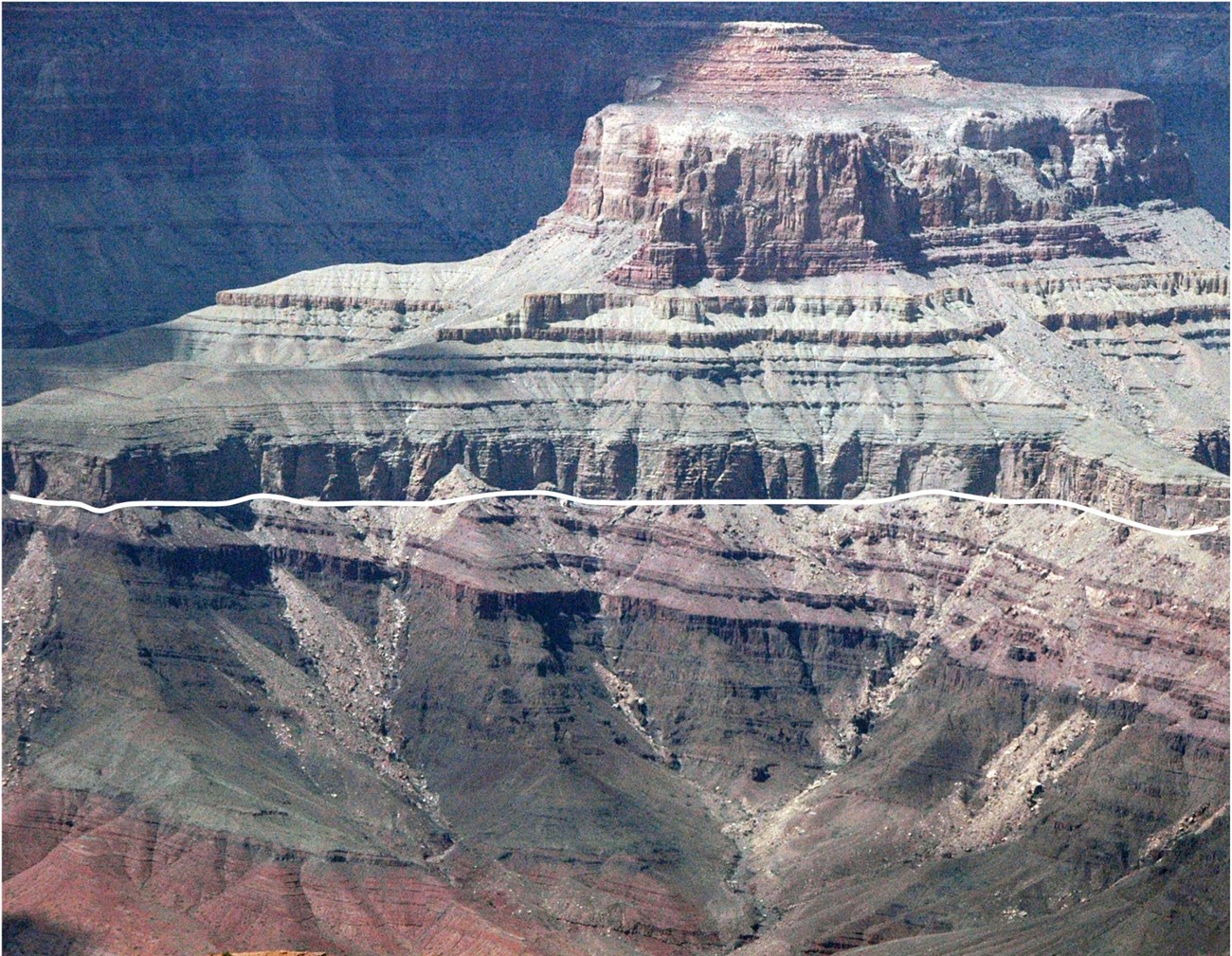 Photo of banded rocky cliffs.