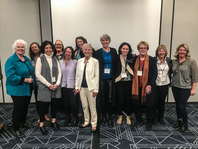 A group photo of women dressed for a conference