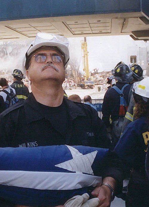 US Park Policeman Tom Wilkins holding an American flag.
