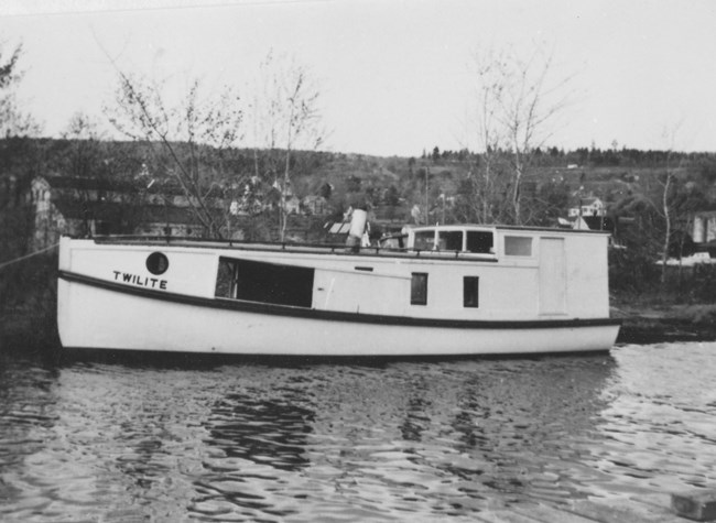 Boat named Twilite at a dock.