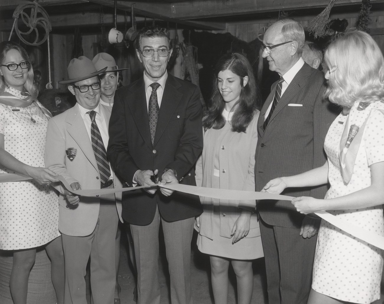 Ribbon cutting ceremony with men and women in NPS dress