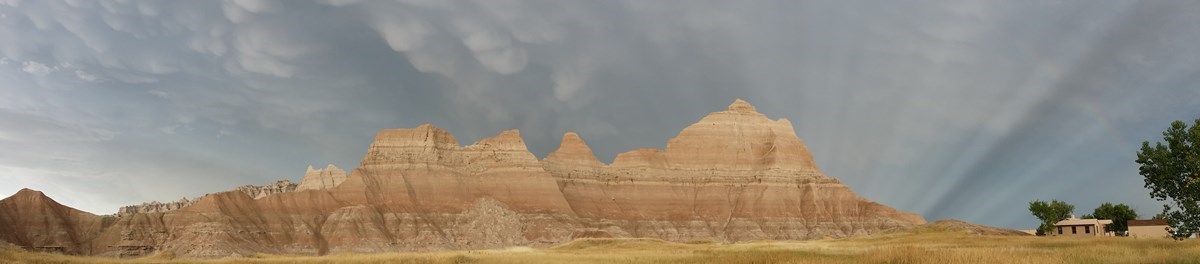 dark cloud cover over badlands buttes