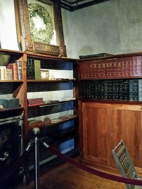 gray concrete walls with a small safe, bookcase and books