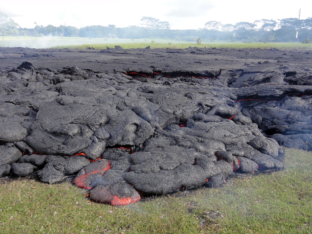 photo of hot lava deposit on a grassy field