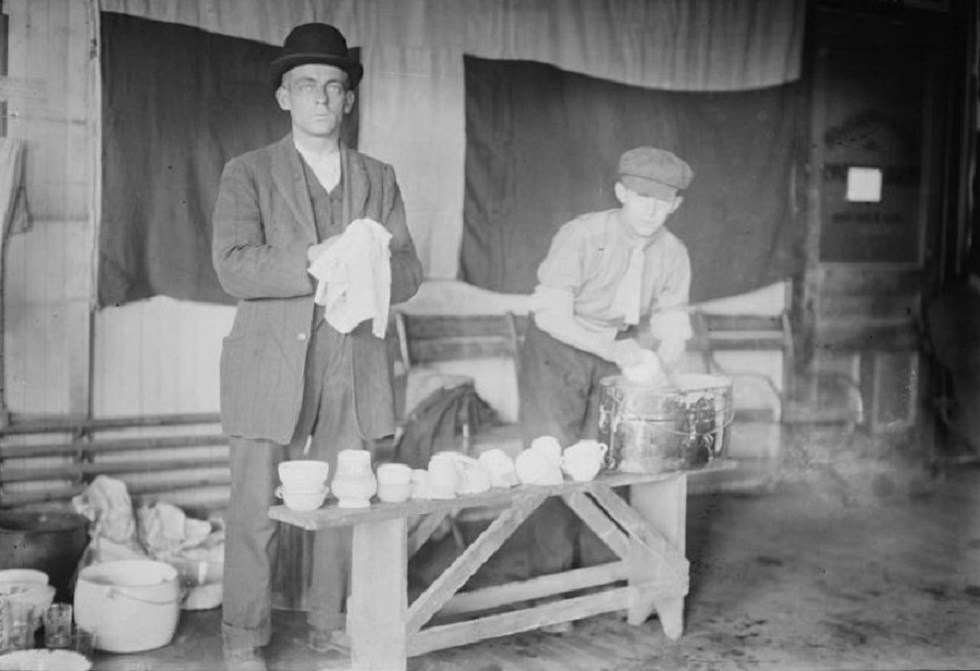Black and white photo of two men washing dishes early 1900's