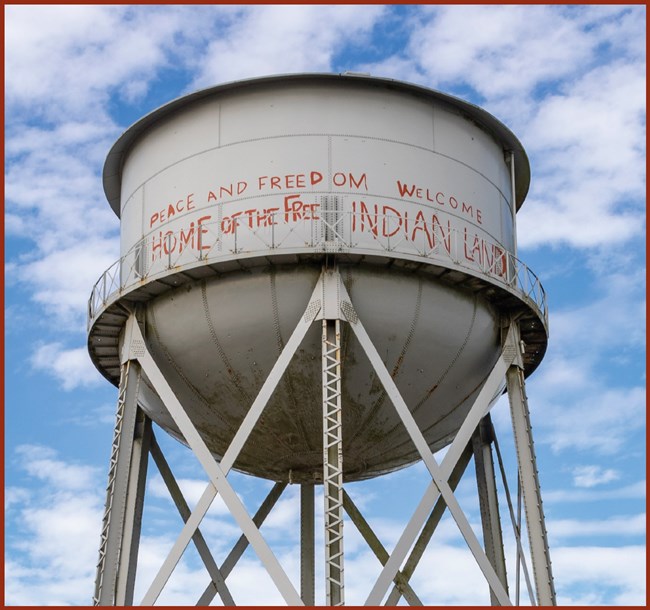 water tower with peace freedom home of the free welcome to indian land on it