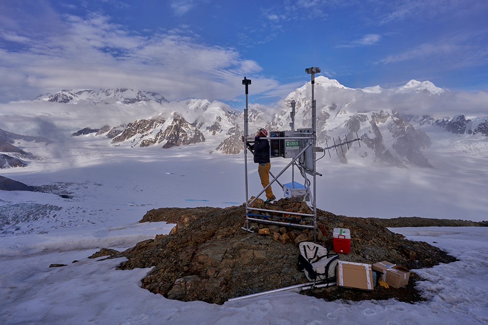A researcher maintains a weather station on a glacier.