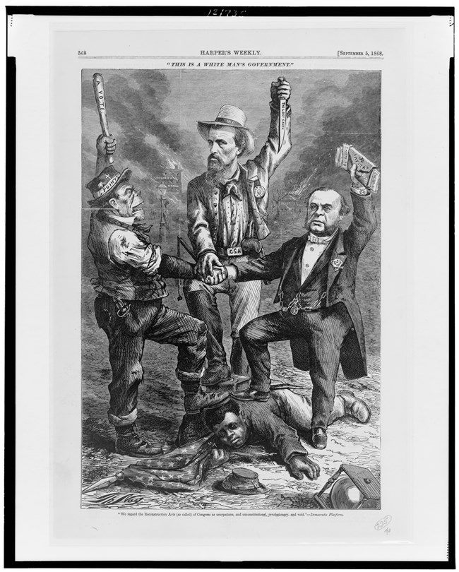 Black and white political cartoon of three men in suits and hats holding their arms in the air, with all their feet on top of an African American man laying on his stomach