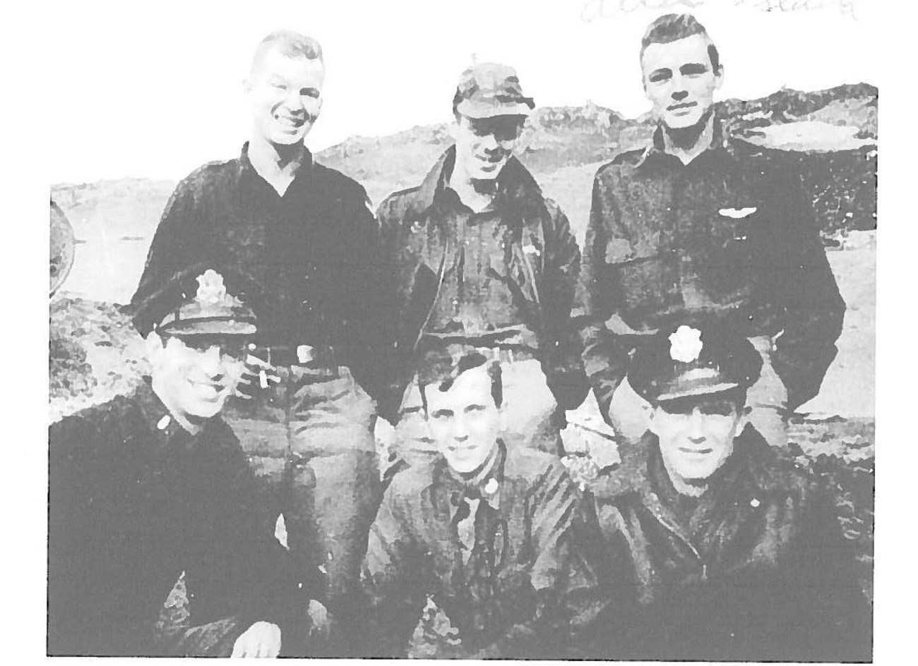 Black and white photo of six men in sailor or pilot uniforms.