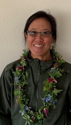 closeup of woman wearing a lei over her suit