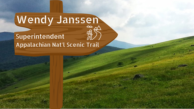 digital illustration of trail sign with text Wendy Janssen, Superintendent, Appalachian Natl Scenic Trail, over a photo of a grassy hillside