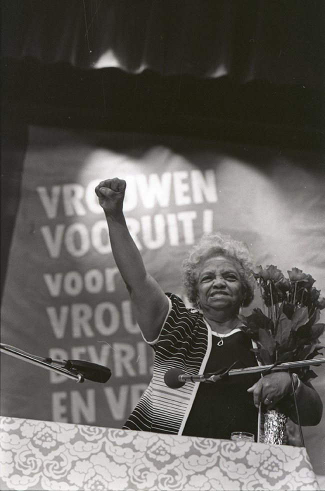 Woman with her arm raised in the air.