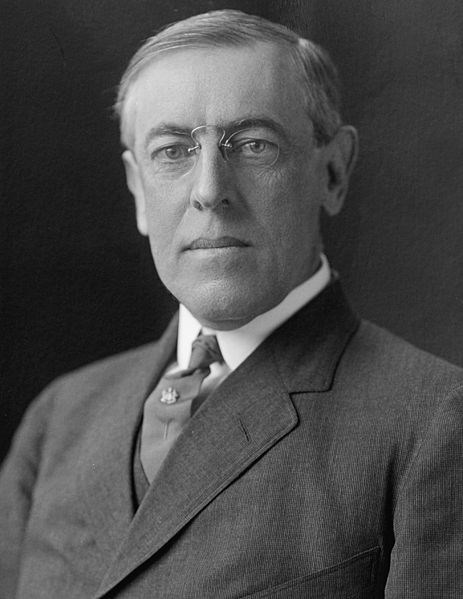woodrow_wilson-he man with gray hair and glasses is wearing a suit