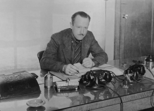 Dorr Yeager sitting at his desk.