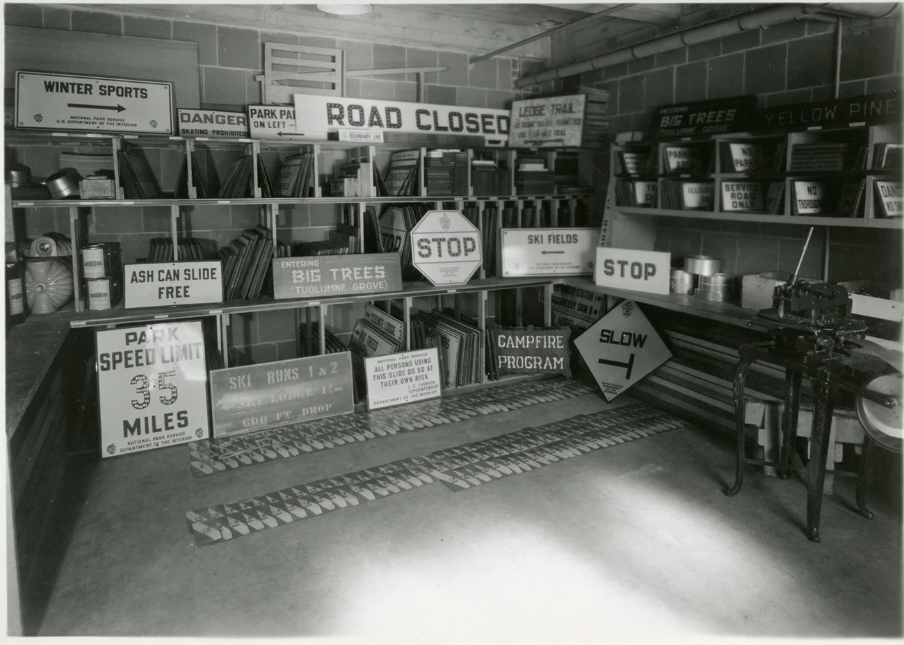 Yosemite sign shop View into a room stacked with different kinds of road signs