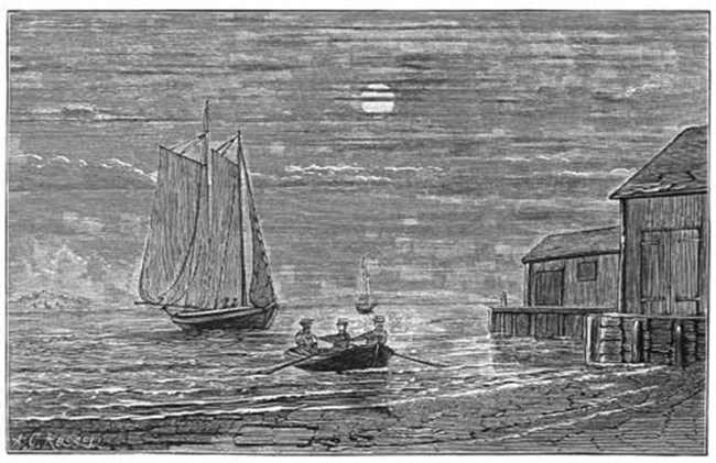 A small boat with 3 people rowing to a larger ship in the Boston Harbor.