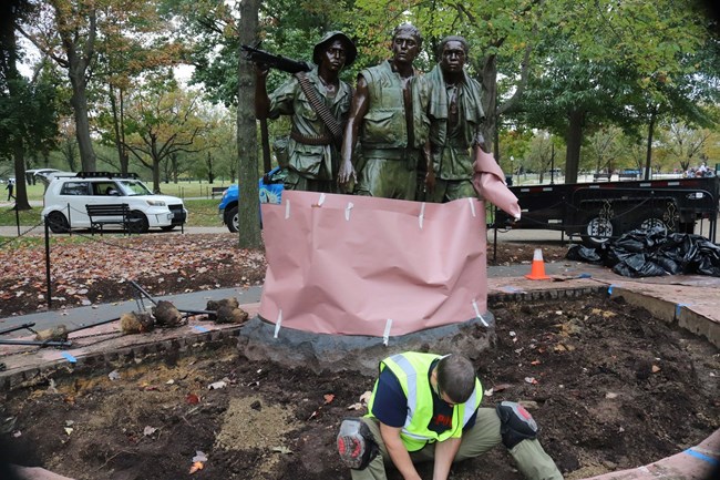 Landscaping is added to the plaza around the Three Servicemen statue at the Vietnam Veterans Memorial