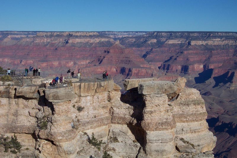 Grand Canyon's Mather Point. Grand Canyon outcropping with visitors sightseeing on top.