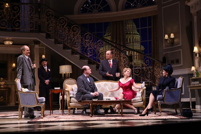 Actors in a living room set on stage