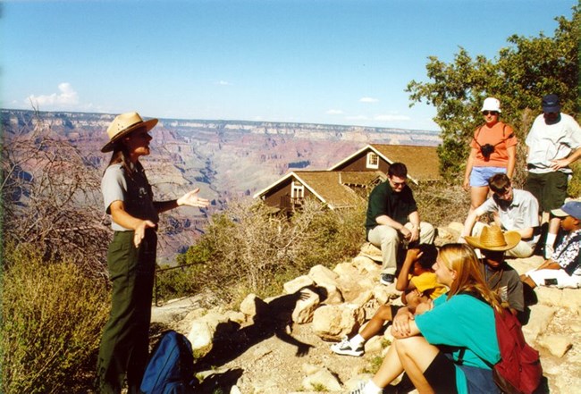 Ranger talk near Kolb Studio. A ranger gives a talk to several visitors in front of Grand Canyon.